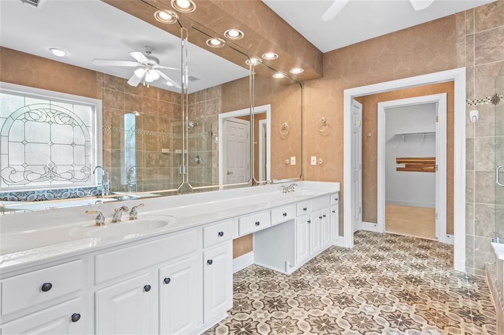 4751 Rosebrook Place Southeast Atlanta, GA 30339 - Photo 26 of 59 a bathroom with a sink double vanity and a shower