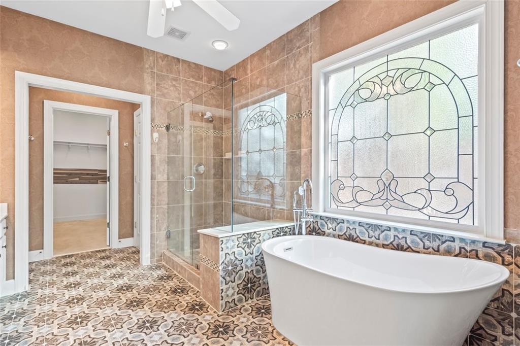 4751 Rosebrook Place Southeast Atlanta, GA 30339 - Photo 27 of 59 a bathroom with a bathtub and a shower