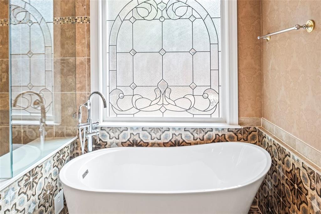 4751 Rosebrook Place Southeast Atlanta, GA 30339 - Photo 28 of 59 a bathroom with a bathtub and shower