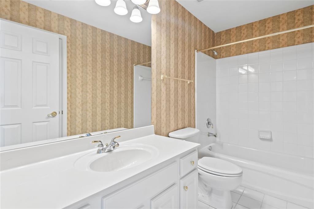 4751 Rosebrook Place Southeast Atlanta, GA 30339 - Photo 40 of 59 a bathroom with a sink a toilet and shower