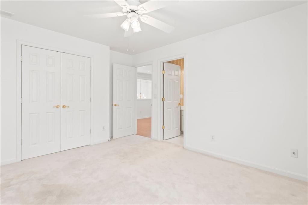 4751 Rosebrook Place Southeast Atlanta, GA 30339 - Photo 42 of 59 an empty room with a chandelier fan and closet area
