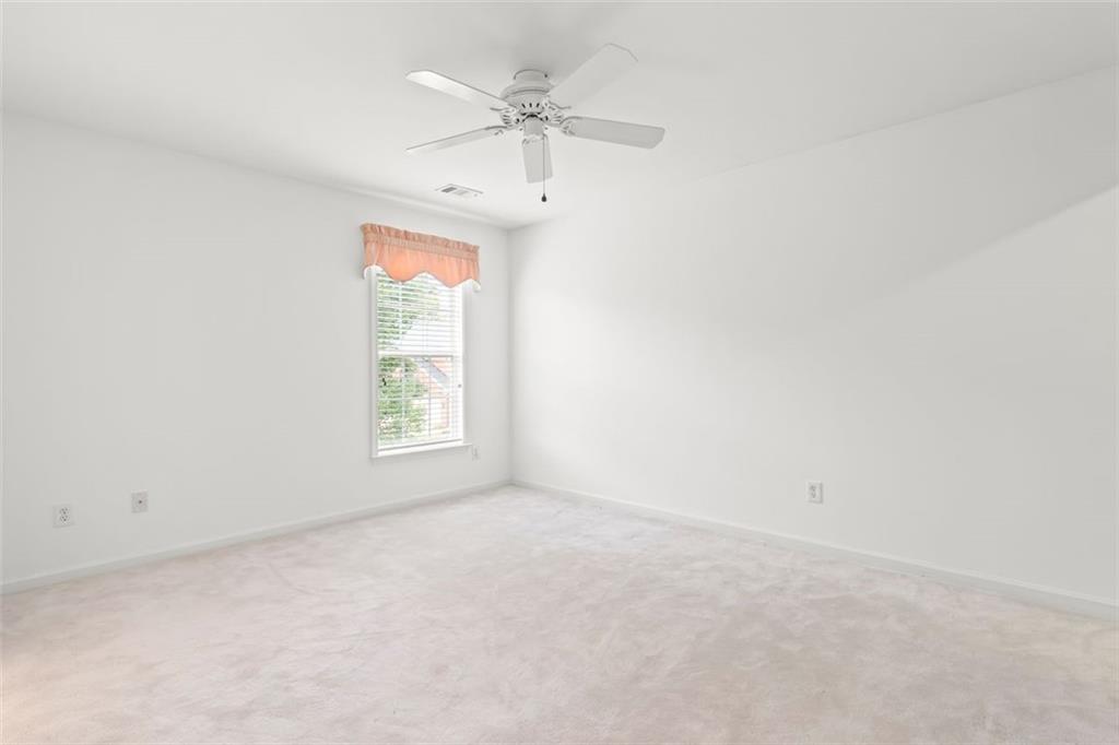 4751 Rosebrook Place Southeast Atlanta, GA 30339 - Photo 49 of 59 an empty room with a window and a fan