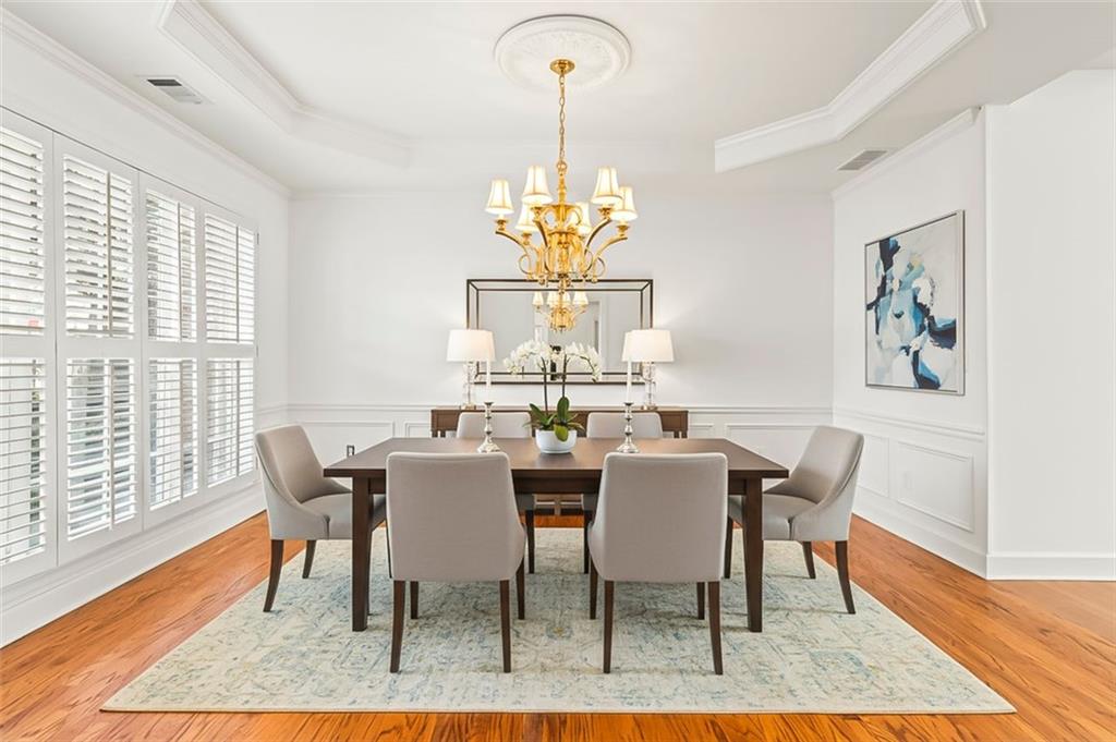 4751 Rosebrook Place Southeast Atlanta, GA 30339 - Photo 5 of 59 a view of a dining room with furniture a rug and wooden floor