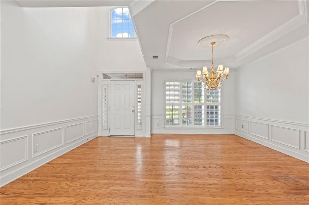 4751 Rosebrook Place Southeast Atlanta, GA 30339 - Photo 6 of 59 a view of an empty room with a window and wooden floor