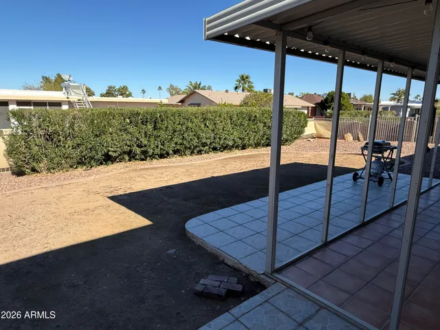 a view of a patio with a yard