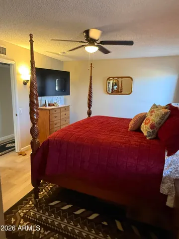 a bedroom with a bed and a flat screen tv