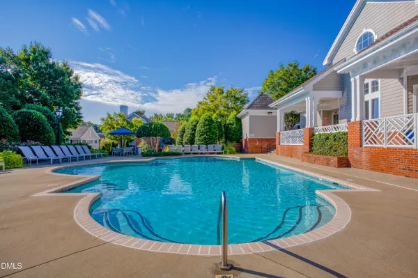 a view of a swimming pool with sitting area