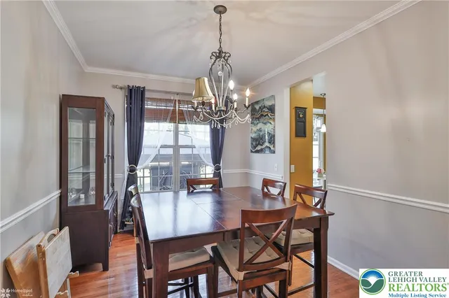 a living room with furniture a fireplace and a floor to ceiling window