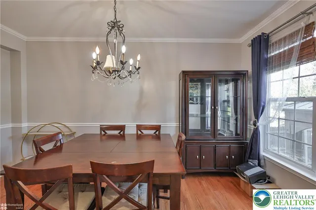 a kitchen with stainless steel appliances kitchen island granite countertop a table and chairs in it