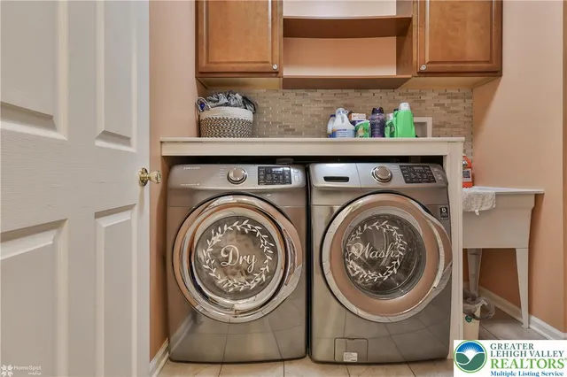 a kitchen with stainless steel appliances kitchen island granite countertop a refrigerator and a stove top oven