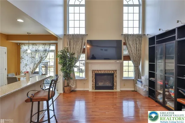 a kitchen with granite countertop a sink a stove cabinets and wooden floor