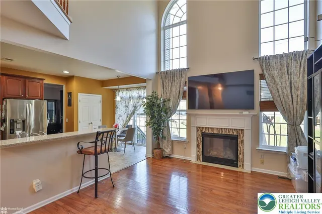 a kitchen with stainless steel appliances granite countertop a sink dishwasher stove and refrigerator with wooden cabinet