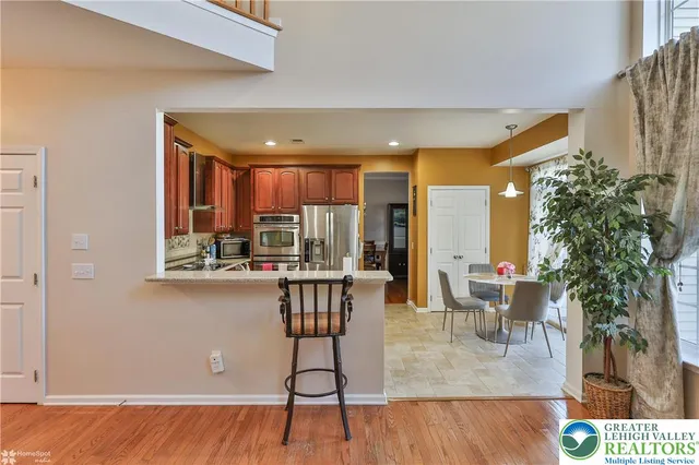 a spacious bedroom with a bed and wooden floor