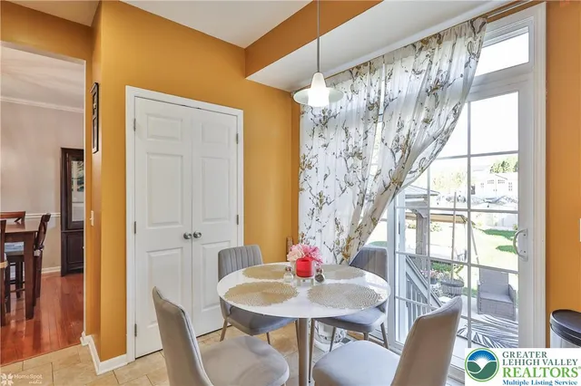 a view of a hallway with wooden floor and closet