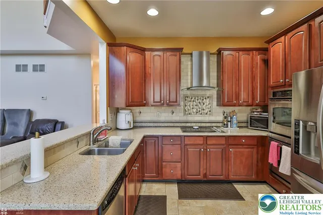 a view of a patio with couches chairs and a backyard