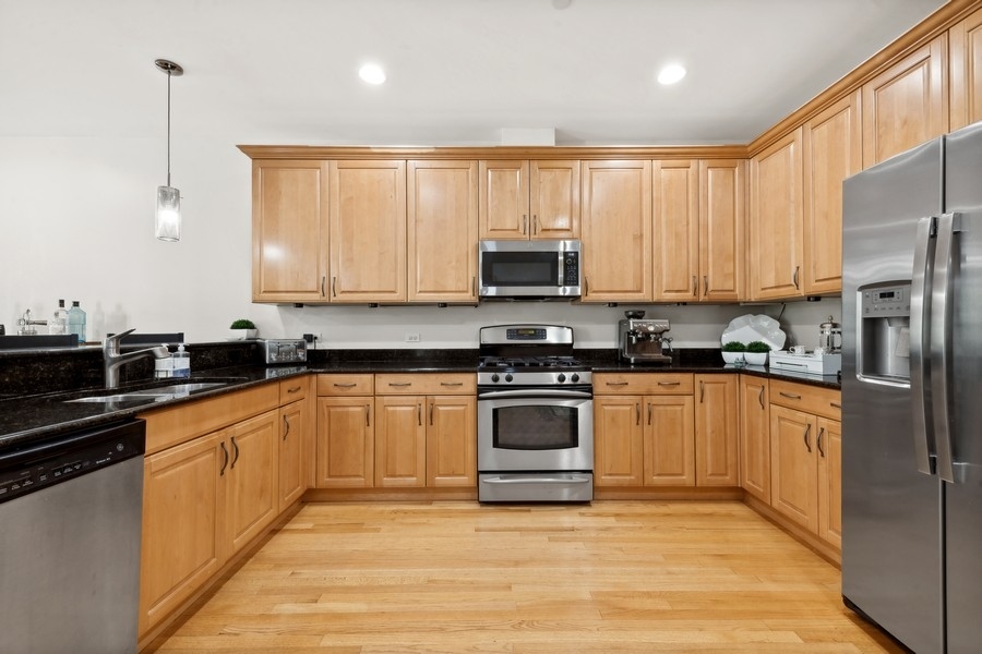 1918 Lynn Circle Libertyville, IL 60048 - Photo 4 of 17 a kitchen with stainless steel appliances a sink a stove a microwave and a refrigerator