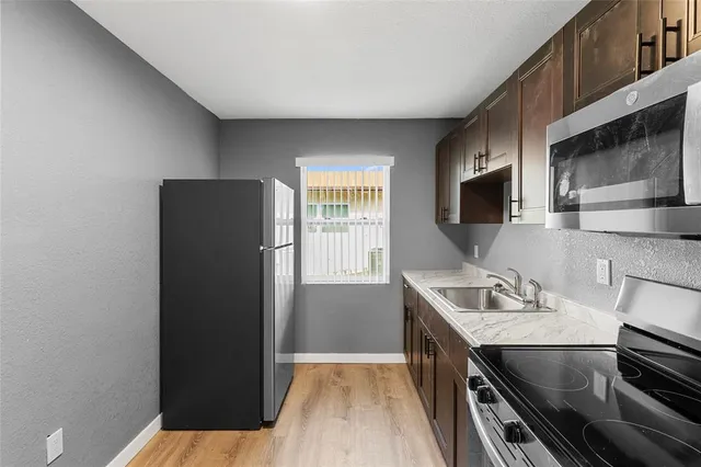 a kitchen with a refrigerator and a sink