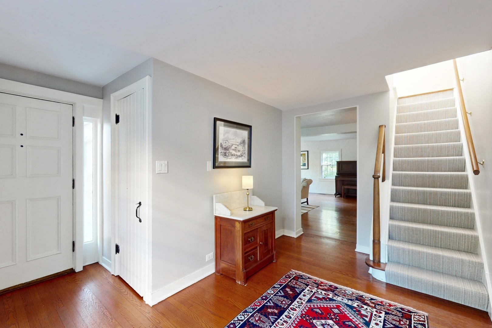 687 Hill Road Winnetka, IL 60093 - Photo 3 of 54 a view of a hallway with wooden floor and cabinet