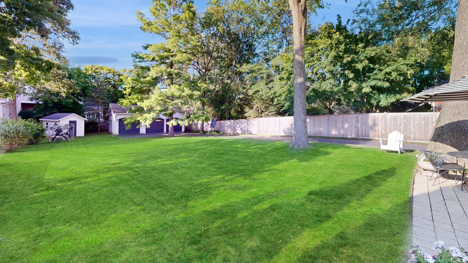 687 Hill Road Winnetka, IL 60093 - Photo 48 of 54 a view of a house with a backyard porch and sitting area