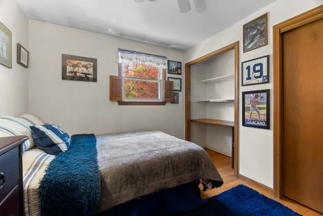 a bedroom with a bed and a window