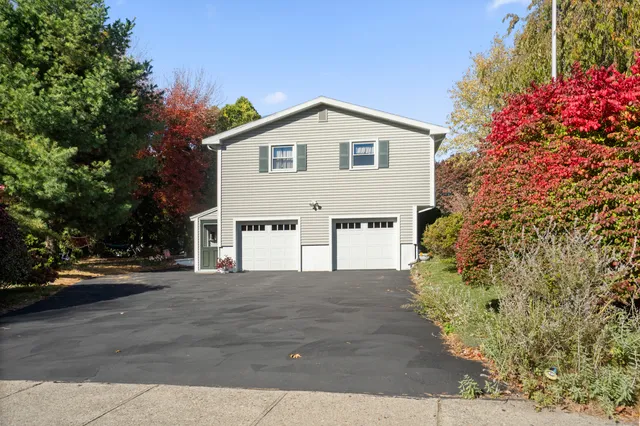 a view of a house with a yard and pathway