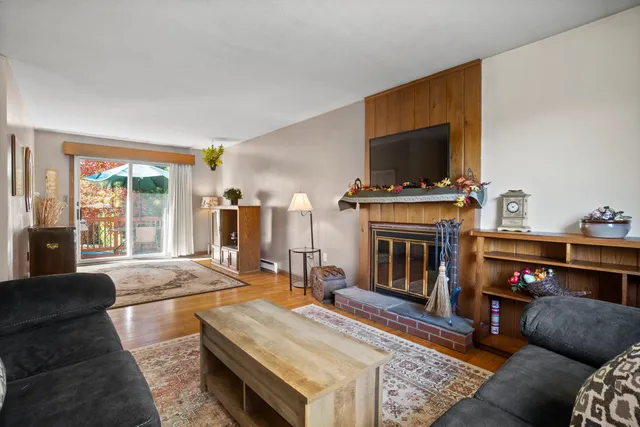 a living room with furniture fireplace and flat screen tv
