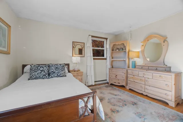 a bed room with a bed and a dresser