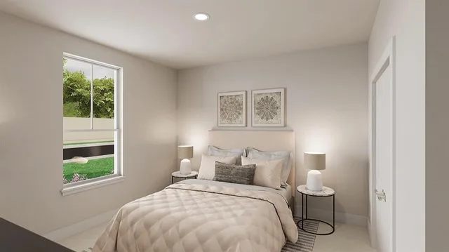 a bedroom with a bed and a window