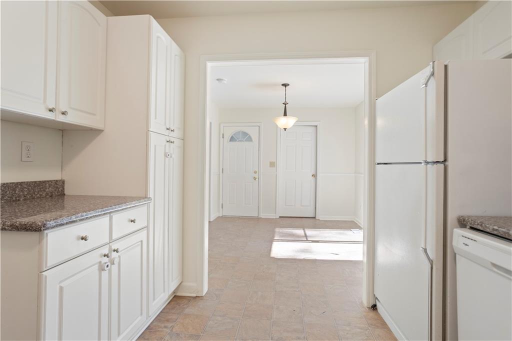 4433 Locksley Road Tucker, GA 30084 - Photo 13 of 33 a bathroom with a granite countertop sink and a refrigerator
