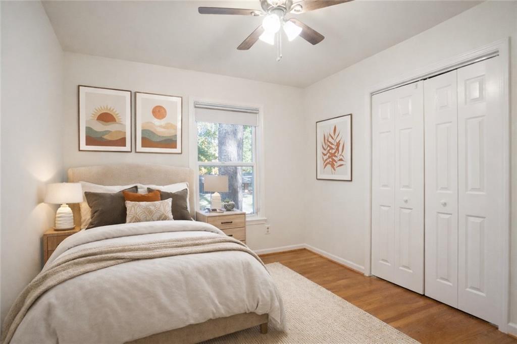 4433 Locksley Road Tucker, GA 30084 - Photo 15 of 33 a bedroom with a large bed and a chandelier