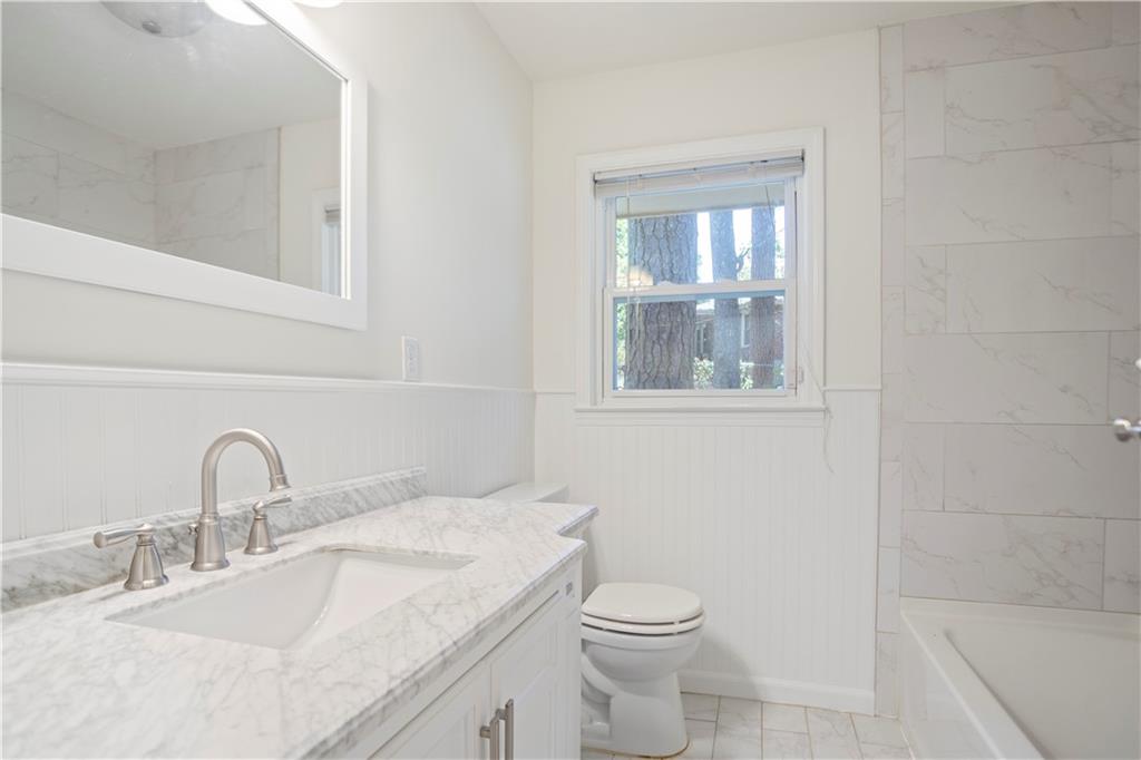 4433 Locksley Road Tucker, GA 30084 - Photo 17 of 33 a bathroom with a toilet sink and mirror