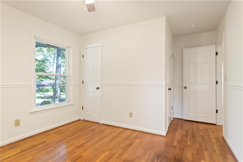 4433 Locksley Road Tucker, GA 30084 - Photo 21 of 33 an empty room with wooden floor and windows