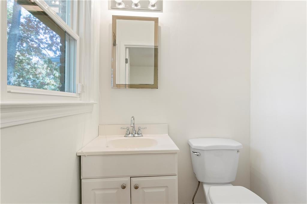 4433 Locksley Road Tucker, GA 30084 - Photo 22 of 33 a bathroom with a toilet sink and mirror