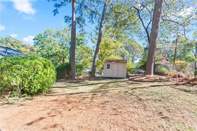 a backyard of a house with large trees and a large tree