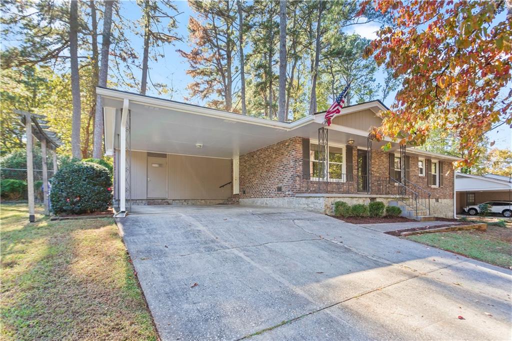 4433 Locksley Road Tucker, GA 30084 - Photo 31 of 33 front view of a house with a yard and trees