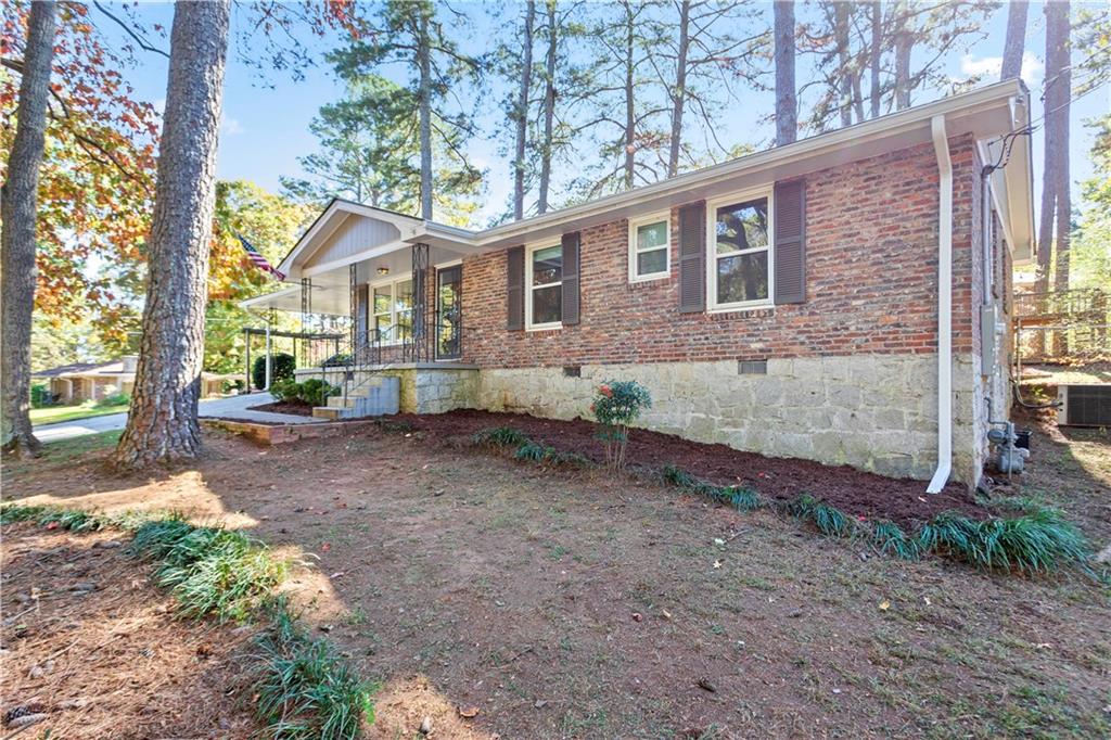 4433 Locksley Road Tucker, GA 30084 - Photo 32 of 33 a view of a house with a yard