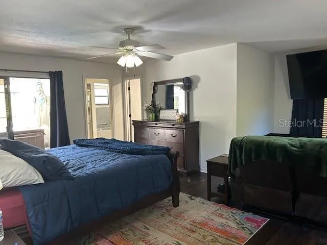a bedroom with a bed dresser and a window