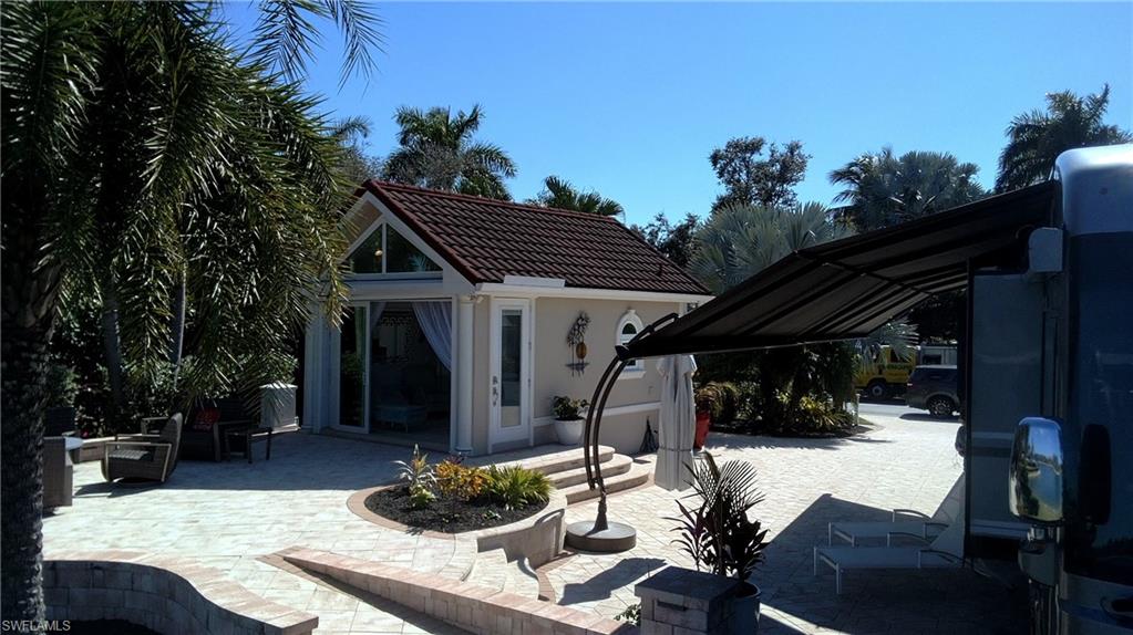 4565 Southern Breeze Drive Naples, FL 34114 - Photo 8 of 19 View of patio / terrace with an outdoor structure and a storage structure
