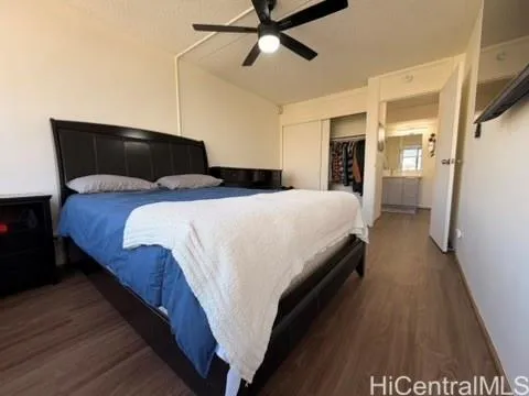 a bedroom with bed and wooden floor