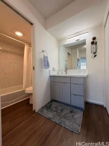 a view of kitchen with stainless steel appliances granite countertop a sink and wooden floor