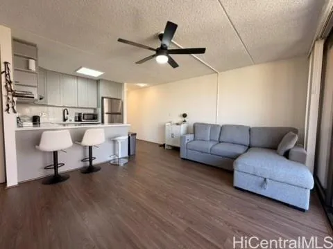 a living room with furniture and kitchen view