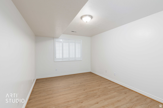2327 Bluff Ridge Drive Syracuse, UT 84075 - Photo 36 of 66 Spacious room featuring wood-finish flooring and white walls