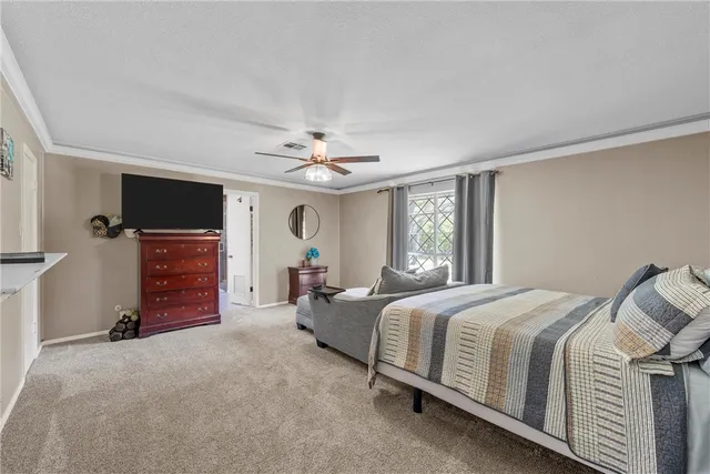 a living room with furniture and a ceiling fan