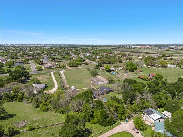 an aerial view of residential houses with outdoor space and river
