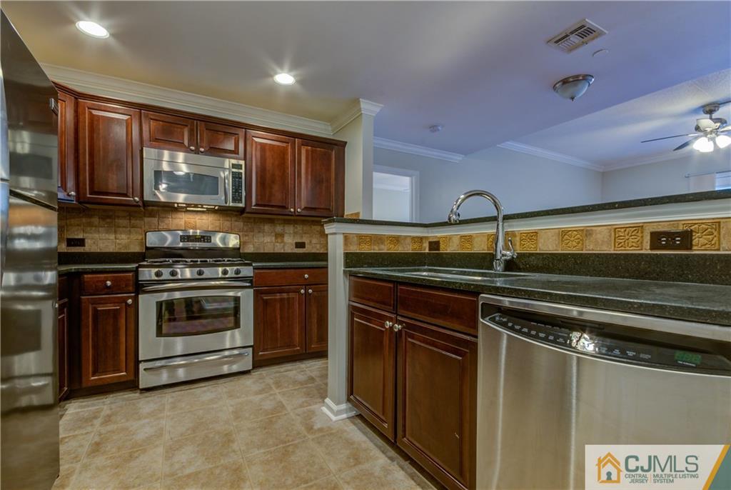 358 Rector Street, Unit 607 Perth Amboy, NJ 08861 - Photo 11 of 25 a kitchen with a stove and a microwave