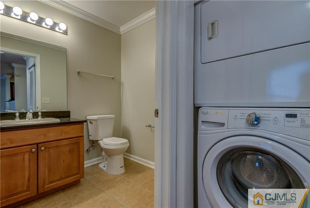 358 Rector Street, Unit 607 Perth Amboy, NJ 08861 - Photo 13 of 25 a bathroom with a toilet sink and mirror