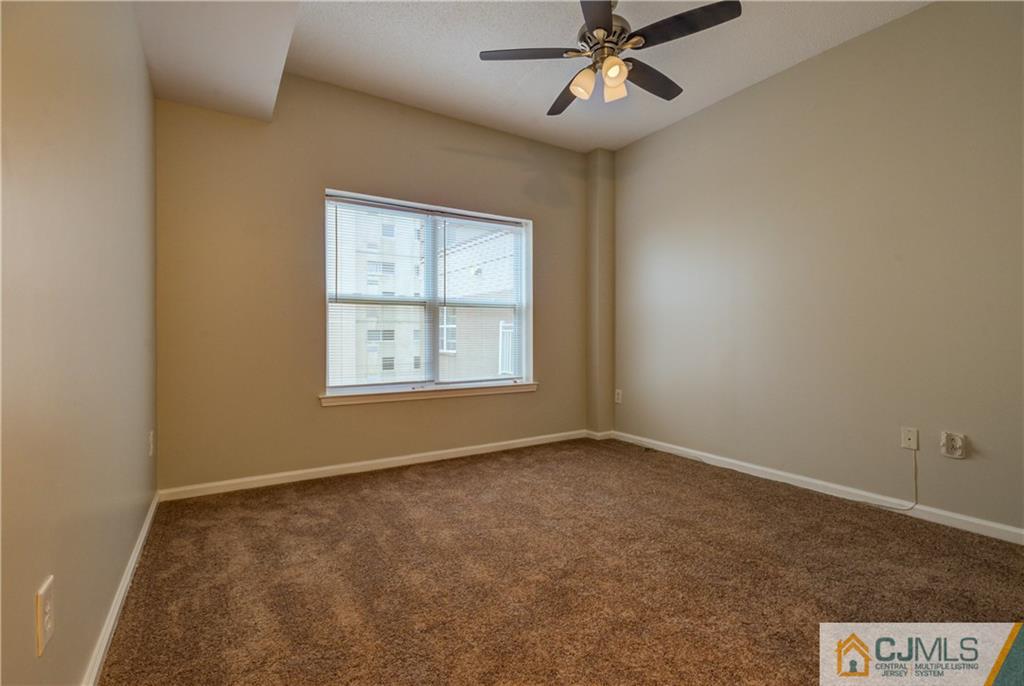 358 Rector Street, Unit 607 Perth Amboy, NJ 08861 - Photo 15 of 25 an empty room with windows and fan