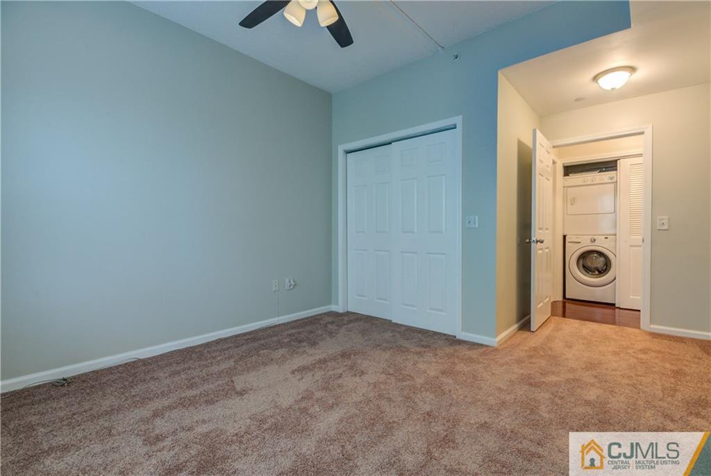 358 Rector Street, Unit 607 Perth Amboy, NJ 08861 - Photo 16 of 25 an empty room with closet and a chandelier fan