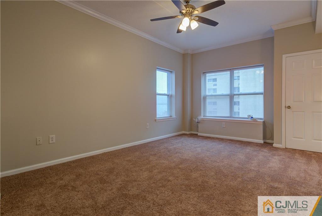 358 Rector Street, Unit 607 Perth Amboy, NJ 08861 - Photo 18 of 25 an empty room with windows and fan