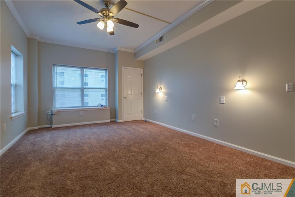 358 Rector Street, Unit 607 Perth Amboy, NJ 08861 - Photo 19 of 25 an empty room with a window and a ceiling fan